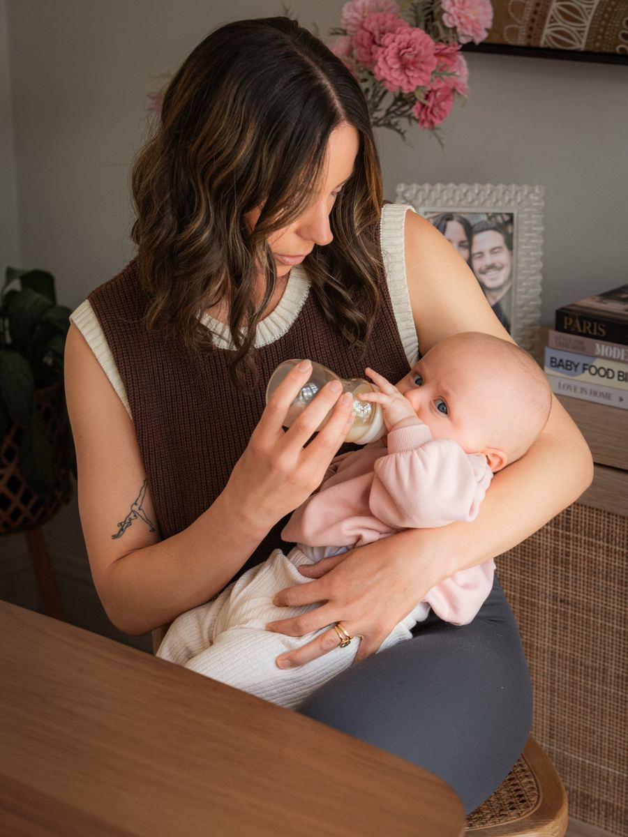 The same mom feeding her baby with a Minbie bottle
