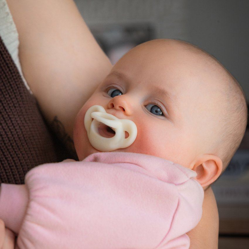A baby with a Milk-colored Minbie pacifier
