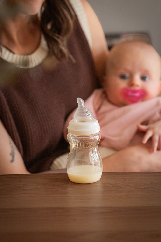 Minbie bottle with a parent and baby