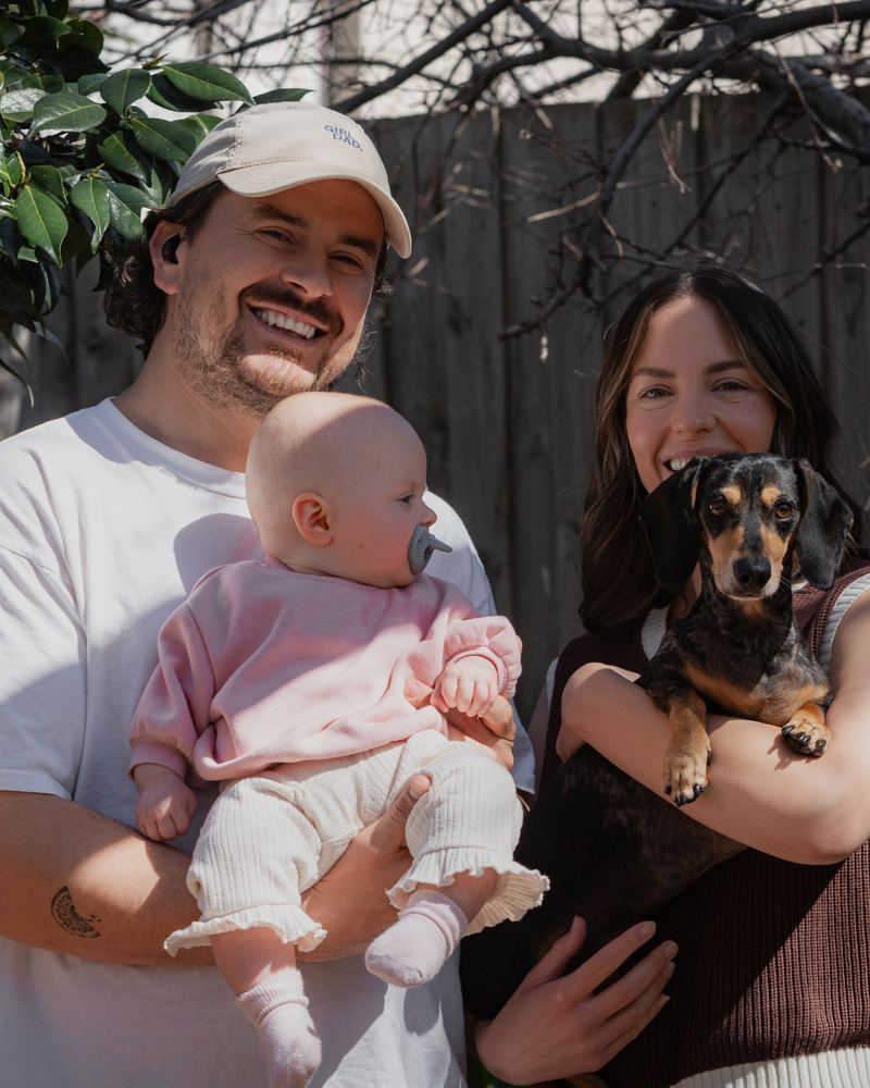 Parents with their baby, who has a Grey Minbie pacifier